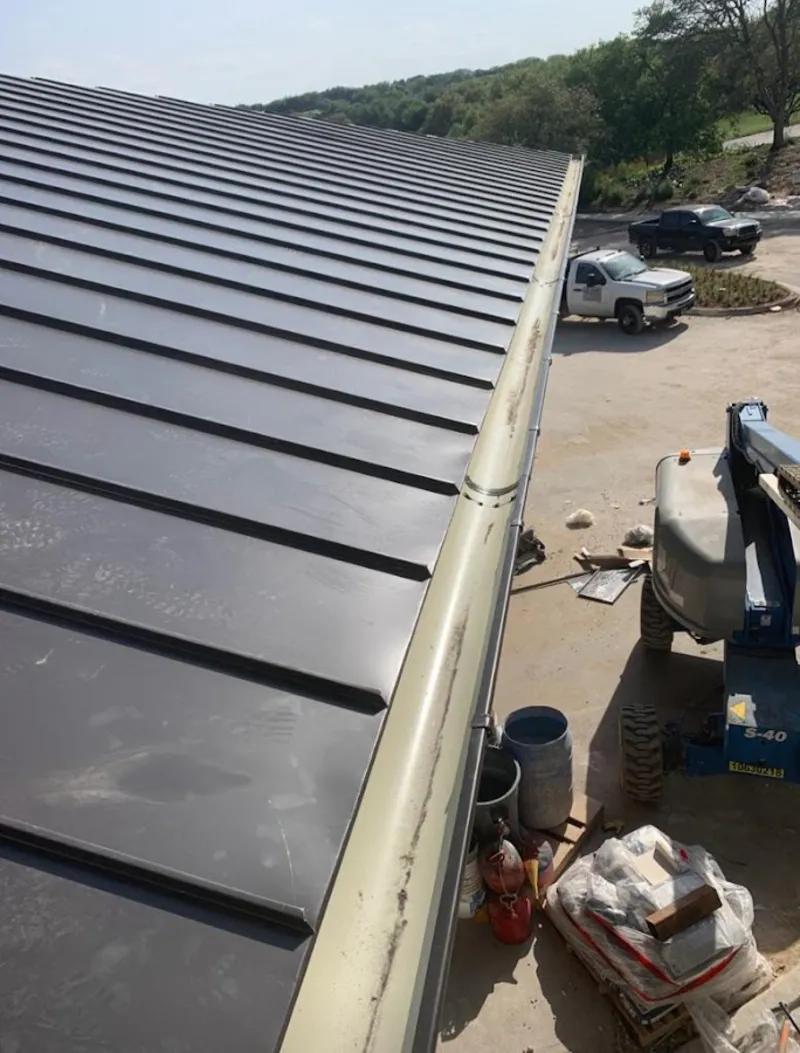 Standing seam panel and gutter detail on a metal roofing jobsite in Carbondale